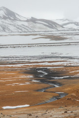 Panorama of geothermal area Hverar&ouml;nd (Hverir), situated by the orange-red clay coloured tuff mountain Namafjall south of N&aacute;maskar&eth; in Iceland, with details and patterns