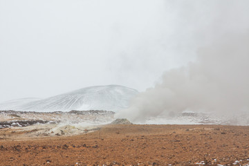 Panorama of geothermal area Hverarönd (Hverir), situated by the orange-red clay coloured tuff mountain Namafjall south of Námaskarð in Iceland, with details and patterns