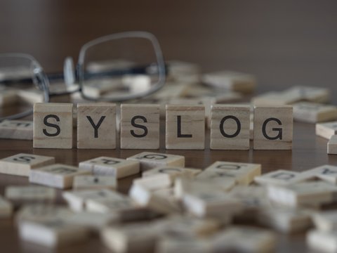 The concept of Syslog represented by wooden letter tiles