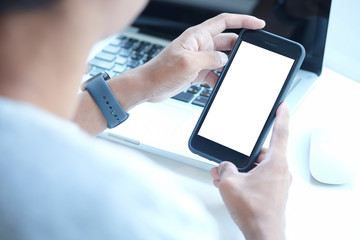 Cropped shot view of man hands holding smart phone with blank copy space screen for your text message or information content, female reading text message on cell telephone during in urban setting. 