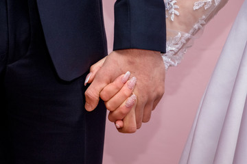 Happy brides holding hands, closeup. Happiness concept_