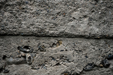 Fototapeta premium Texture of uneven old concrete slab. Background image macro photo of concrete