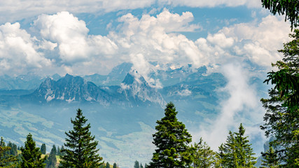 Switzerland, Panoramic view on green Alps and Mythens peak in clouds