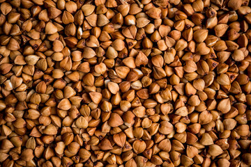 The texture of dry buckwheat. Background image of buckwheat porridge. Maro's Photo