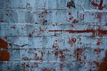 Texture of an old paint covered brick wall. Background image of an abandoned brick wall with painted over paint