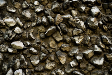 Texture photo of rough concrete plaster with sprinkled gravel