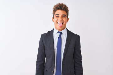Young handsome businessman wearing suit standing over isolated white background sticking tongue out happy with funny expression. Emotion concept.