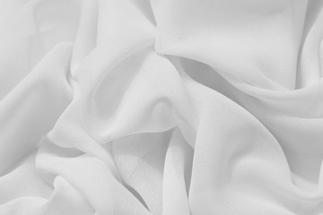 Obraz premium Light draped chiffon fabric in light color for festive backgrounds
