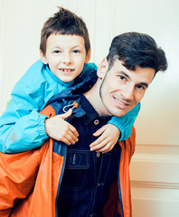 young handsome father with his son fooling around at home, lifestyle people concept close up