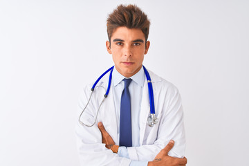 Young handsome doctor man wearing stethoscope over isolated white background skeptic and nervous, disapproving expression on face with crossed arms. Negative person.