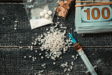 Hard drugs on dark table.Addiction concept. Drug syringe and cooked heroin