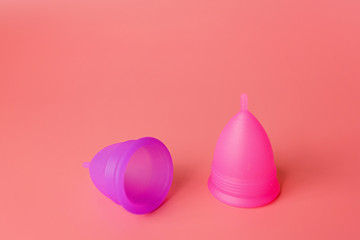 Menstrual cups on pink background. Alternative feminine hygiene product during the period. Women health concept. Copy space. Eco friendly concept, zero waste product. mockup, template