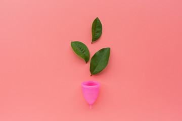 Menstrual cup on pink background. Alternative feminine hygiene product during the period. Women...
