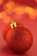 Christmas time. New Year's toys balls red close-up on red   background with yellow bokeh.Christmas tree decor.