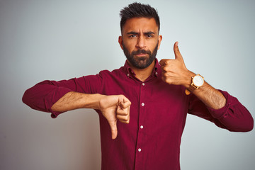 Young indian man wearing red elegant shirt standing over isolated grey background Doing thumbs up...