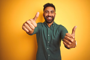 Young indian businessman wearing elegant shirt standing over isolated white background approving...