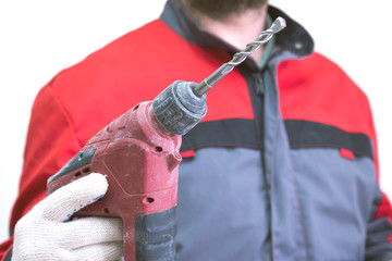 a man in a suit installer on his hand wearing a glove holding a puncher