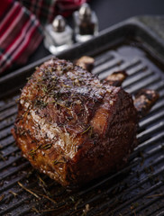 Grilled piece of meat with bone in a grill pan. Fried steak. Roasting - Medium Rare