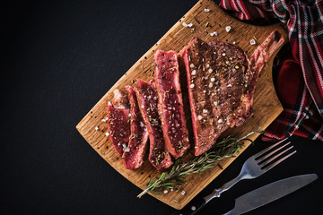 Entrecote. Steak on the bone. Rib eye. Tomahawk steak on the on a cutting board with rosemary....