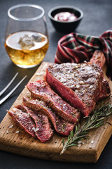 Entrecote. Steak on the bone. Rib eye. Tomahawk steak on the on a cutting board with rosemary. Roasting - Rare