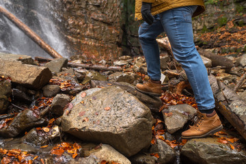man hiking concept looking at waterfall in dip forest