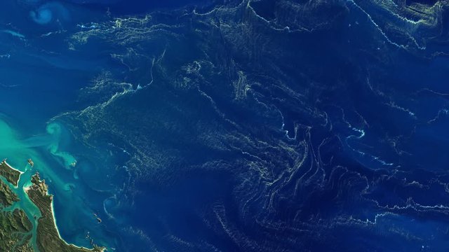 Aerial satellite view of micro organism bacteria patches on ocean surface near great barrier reef Australia. Contains public domain image by Nasa