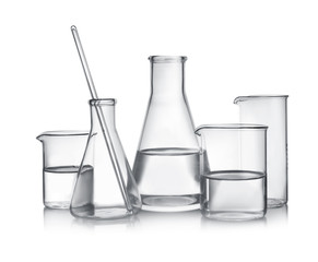 Laboratory glassware with liquid samples on white background