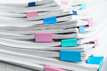 Stack of documents with binder clips, closeup
