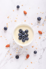 Yogurt with fresh blueberries on wooden background. Health concept.