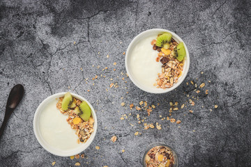 Top view of yogurt in bowl with granola,fresh kiwi