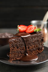 Delicious fresh chocolate cake with strawberry on grey table