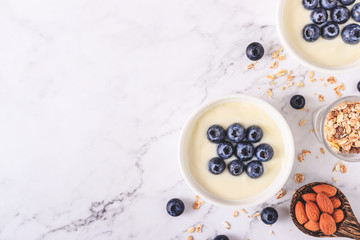 Fototapeta na wymiar Yogurt with fresh blueberries on wooden background. Health concept.