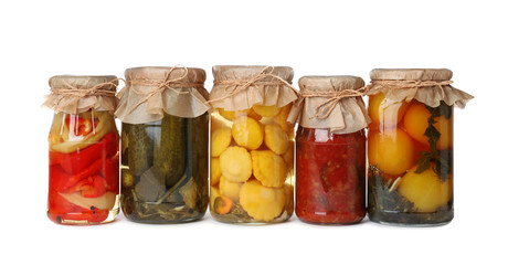 Fototapeta na wymiar Different jars with pickled vegetables on white background