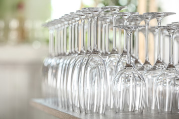 Empty glasses on wooden table against blurred background