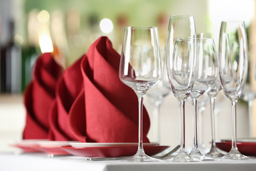 Table setting with empty glasses, plates and cutlery on table