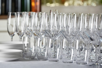 Set of empty glasses and dishware on table indoors