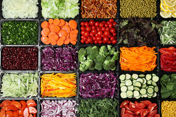 Salad bar with different fresh ingredients as background, top view