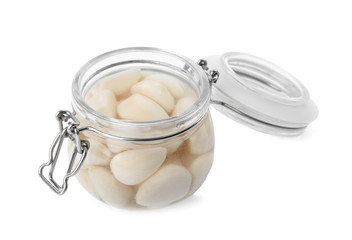 Jar with pickled garlic on white background