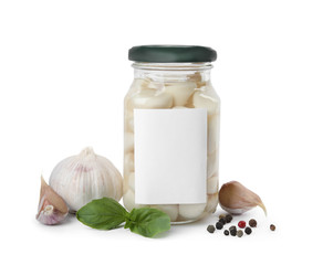 Composition with jar of pickled garlic on white background