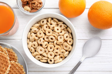 Flat lay composition with corn rings on white wooden table. Healthy breakfast