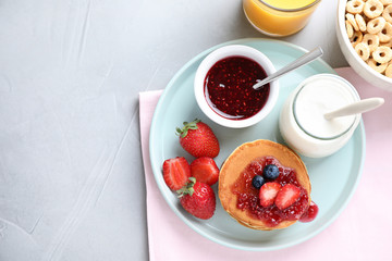 Flat lay composition with tasty pancakes on light grey table, space for text . Healthy breakfast