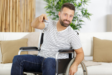 young handicapped man using remote control