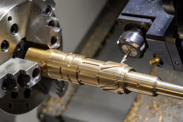 The CNC lathe,multi-tasking machine cutting the groove  slot at the brass shaft with the milling...