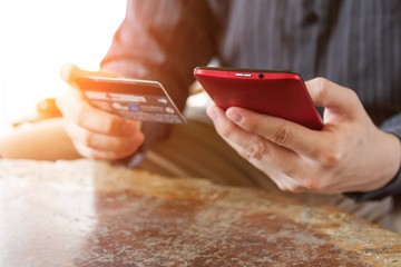 business people holding credit card and using mobile smart phone