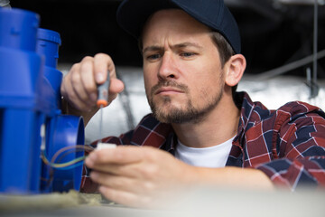 mans hand wiring circuit pump used in the factoryselective focus