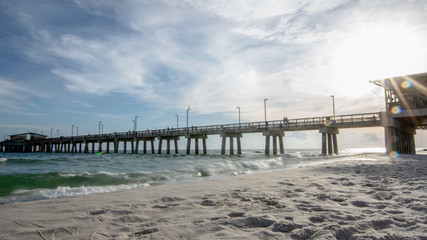 Long exposure of fishing pier with sunburst