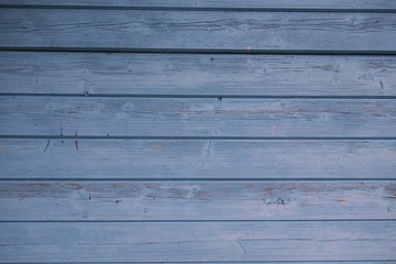 Fototapeta premium Horizontal format of a wooden wall painted blue