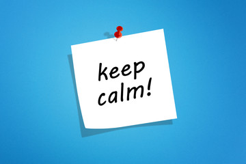 White post it note paper with keep calm message on blue background