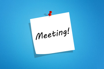 White post it note paper with meeting message on blue background