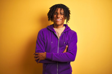 Afro american man with dreadlocks wearing purple sweatshirt over isolated purple background happy face smiling with crossed arms looking at the camera. Positive person.